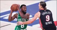  ?? Mark J. Terrill / Associated Press ?? The Boston Celtics’ Kemba Walker works against Miami Heat’s Kelly Olynyk during the second half of an NBA conference final game on Saturday in Lake Buena Vista, Fla.