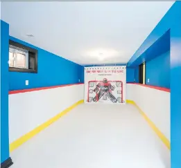  ?? ALEX SCHULDTZ/THE HOLMES GROUP ?? This creative basement “hockey rink” uses durable, white plastic floor tiles for “ice” and protective boards on the wall so the kids can use a real puck. There’s even a penalty box.
