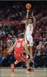  ?? NWA Democrat-Gazette/Andy Shupe ?? GOING FOR THREE: Arkansas guard Jalen Harris (5) takes a 3-point shot over South Dakota guard Cody Kelley during the first half of last Friday’s game in Bud Walton Arena in Fayettevil­le.