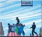  ??  ?? Safe landing: Matt Roeser, 42, who was at the chalet nearby managed to capture the dramatic rescue on camera