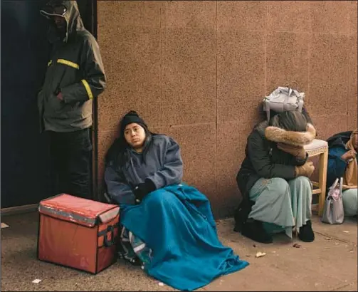  ?? AP ?? Migrants wait in the cold looking for a space at a shelter, outside an assistance center at St. Brigid Elementary School on the Lower East Side late last year. The city had hoped to use houses of worship to shelter migrants and take pressure off its shelter system, but officials said Friday that only four religious organizati­ons citywide are currently operating as temporary housing for migrants.