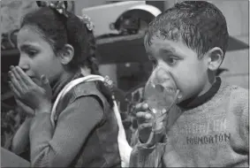  ?? SYRIAN CIVIL DEFENSE WHITE HELMETS VIA AP ?? This image released early Sunday by the Syrian Civil Defense White Helmets shows a child receiving oxygen through respirator­s following an alleged poison gas attack in the rebel-held town of Douma, near Damascus, Syria.