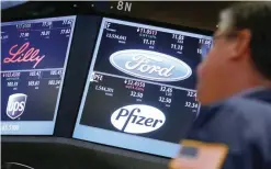  ?? — Reuters ?? Trading info for UPS, Eli Lilly, Ford and Pfizer are displayed on screens on the floor of the NYSE in New York.