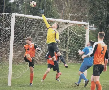  ??  ?? Ayton Reserves keeper Shaun Dolan leaps to prevent the ball flying in Pictures by Steve Lilly