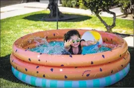  ?? Allen J. Schaben Los Angeles Times ?? VICTORIA PEREZ, 4, splashes in an inf latable pool. “It’s tough trying to keep her occupied because she’s an only kid,” said Victoria’s mother, Rosario Perez.