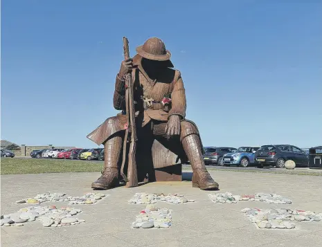  ??  ?? Pebbles laid in tribute to Prince Philip at the Tommy Statue, Seaham. Picture by Frank Reid