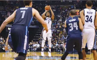  ?? THE ASSOCIATED PRESS ?? Memphis Grizzlies guard Wayne Selden, center, attempts a 3-point shot as Dallas Mavericks forward Dwight Powell, from left, guard Devin Harris and Grizzlies forward Brandan Wright look on during their game Wednesday in Memphis