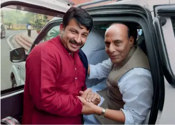  ?? — PTI ?? Union home minister Rajnath Singh with Delhi BJP president Manoj Tiwari at Parliament House during the winter session in New Delhi on Monday.