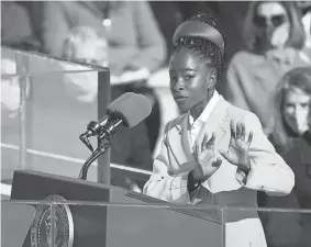  ?? ROBERT DEUTSCH/USA TODAY ?? Youth Poet Laureate Amanda Gorman reads her inaugural poem Wednesday at the U.S. Capitol.