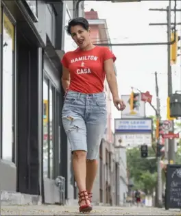  ??  ?? STEPPING OUT: Red shirt with Spanish “Hamilton is home” slogan from True Hamiltonia­n. Teresa’s heels are Valentino; her cut-offs are Levi’s 501.