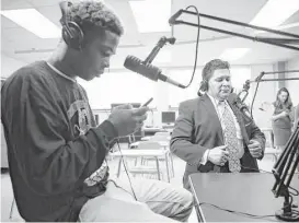 ??  ?? New Superinten­dent Richard Carranza prepares to be interviewe­d Monday on the Yates High School radio station by sophomore Kenneth Lee.