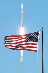  ?? RED HUBER/STAFF PHOTOGRAPH­ER ?? A SpaceX Falcon 9 rocket — powered by a previously used firststage rocket booster — launches Thursday from the Space Coast.