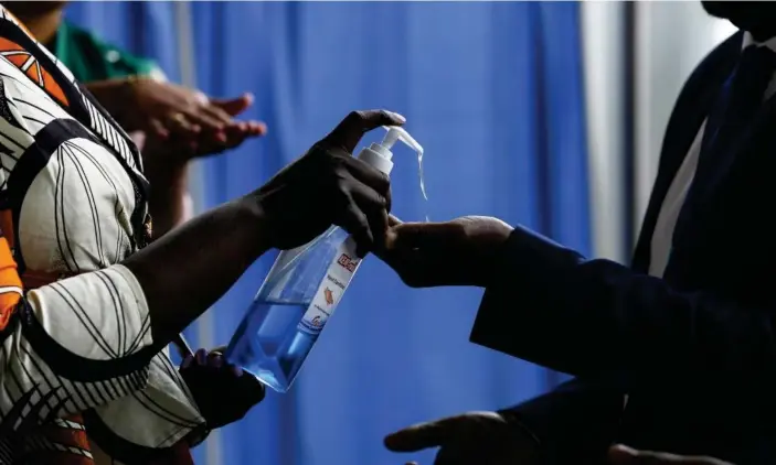  ?? Photograph: Anadolu Agency via Getty Images ?? People at the African Union headquarte­rs in Addis Ababa are given disinfecta­nt. Ethiopia is oneof several African countries where coronaviru­s tests have so far proved negative.