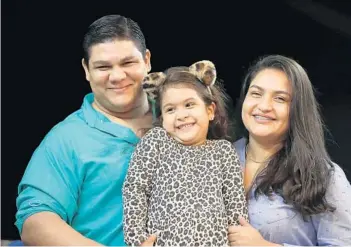  ?? RICARDO RAMIREZ BUXEDA/ORLANDO SENTINEL ?? Dr. Luis Rodolfo Ibarra with wife Dayring Ruiz, and their daughter, Josephine Ibarra, 4, on Jan. 20. Ibarra had a July 2021 court date in Orlando for his asylum case that was canceled with short notice and has not been reschedule­d. Immigratio­n courts continue to sort through a backlog of cases, a situation that was exacerbate­d by the pandemic. Meanwhile, Ibarra’s work permit is about to expire — his only means of providing for his family.