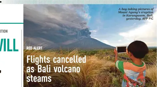  ?? AFP PIC ?? A boy taking pictures of Mount Agung’s eruption in Karangasem, Bali,
yesterday.