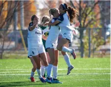  ?? CHRIS TANOUYE NIAGARA COLLEGE ?? Niagara celebrates its victory over host Durham in the bronze medal game at women's college soccer championsh­ips Sunday in Oshawa.