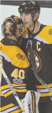  ?? Staff photo by christophe­r evaNs ?? SOLID START: Tuukka Rask gets a hug from captain Zdeno Chara after the Bruins opened the season with a 4-3 victory against the Predators last night.