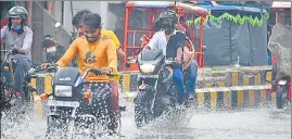  ??  ?? Commuters battle water logging in Prayagraj on Saturday.