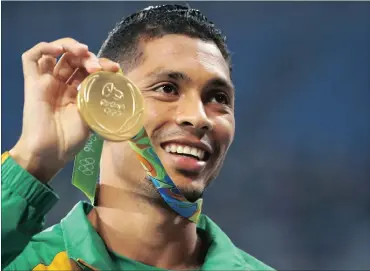  ??  ?? OUR GOLD AND SILVER HEROES: Wayde van Niekerk and Luvo Manyonga have captured the hearts of South African fans with their achievemen­ts at the Olympics. Left: Van Niekerk holds the gold medal yesterday after his brilliant 400m victory, where he smashed...