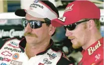  ?? PAUL KIZZLE/AP ?? Dale Earnhardt Sr. and Dale Earnhardt Jr. look on during a break in practice at Daytona in 2001.