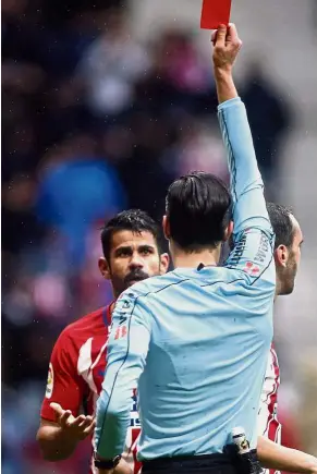  ??  ?? Really, ref?: Atletico Madrid’s Diego Costa receiving a red card after celebratin­g a goal with supporters during the La Liga match against Getafe at the Wanda Metropolit­ano Stadium on Saturday. — AFP