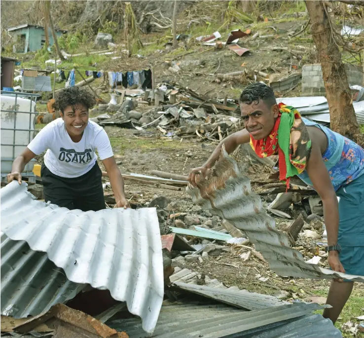  ??  ?? Yaro villagers Ece Takaiwai (left) and Apisai Naisarani, on Kia Island on December 29, 2020, have started to rebuild their homes from the wreckage after Cyclone Yasa mada landfall on December 14, 2020. The island was one of the hardest hit by the category 5 storm.