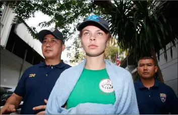  ?? AP PHOTO/SAKCHAI LALIT ?? Thai Immigratio­n police officers escort Belarusian model Anastasia Vashukevic­h (center) from the Immigratio­n Detention Center towards a vehicle to take her to an airport for deportatio­n, in Bangkok, Thailand, on Thursday.