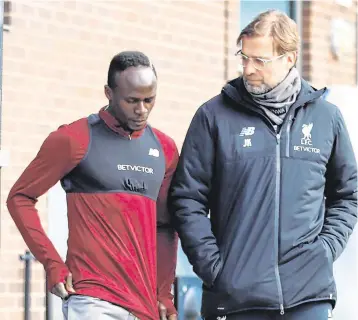  ??  ?? Main Mané: Liverpool manager Jurgen Klopp speaks with striker Sadio Mané at training yesterday