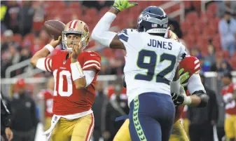  ?? Don Feria / Associated Press ?? 49ers quarterbac­k Jimmy Garoppolo, who took over for C.J. Beathard late in the fourth quarter, completed both of his passes, the last one a 10-yard TD to Louis Murphy (18), top.