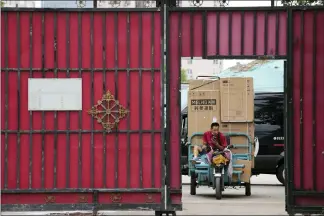  ?? NG HAN GUAN — THE ASSOCIATED PRESS ?? A delivery man transports home appliances from a delivery hub Monday in Beijing. China’s central bank trimmed a key interest rate Monday to shore up sagging economic growth at a politicall­y sensitive time when President Xi Jinping is believed to be trying to extend his hold on power.