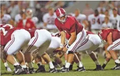  ?? ALABAMA PHOTO/KENT GIDLEY ?? Alabama quarterbac­k Jay Barker looks toward his backfield during the 29-28 comeback triumph over Georgia in 1994.