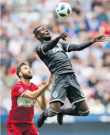  ?? — THE CANADIAN PRESS FILES ?? Vancouver Whitecaps’ Kei Kamara, right, jumps above Chicago Fire’s Jonathan Campbell and traps the ball with his chest during the first half of an MLS soccer game in Vancouver, on Saturday.