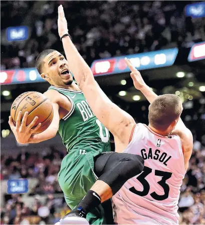  ?? FRANK GUNN THE CANADIAN PRESS ?? Celtics forward Jayson Tatum commits an offensive foul against Raptors centre Marc Gasol on Tuesday at Scotiabank Arena.