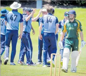 ??  ?? Te Puke’s Josh Earl celebrates with teammates after taking the wicket of Ben Musgrave.