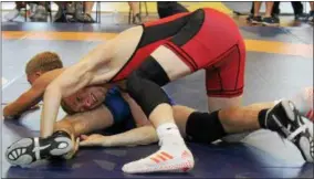  ?? PHOTO COURTESY JOANN BURKE ?? Zach Burke, in red, wrestles an opponent during the 2016Down Under Sports Wrestling Tournament in Australia.