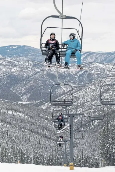  ?? Photos by AAron Ontiveroz, The Denver Post ?? Michael Betyo, left, and Caleb Jeffery, both on spring break from Arkansas, ride the chairlift at Echo Mountain on Thursday.