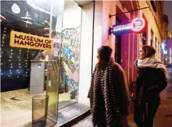  ??  ?? Two women walk past the Museum of Hangovers in Zagreb on Dec 3, 2019. — AFP photos