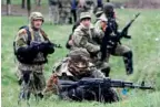  ?? — AFP ?? Pro-Russia forces take their position to battle Ukrainian police special team near the eastern Ukrainian city of Slovyansk on Sunday.