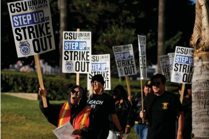  ?? ?? Members with Teamsters Local 2010 join California Faculty Associatio­n and other CSU unions at a rally on 14 November. Photograph: Damian Dovarganes/AP