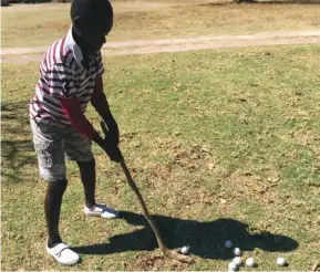  ??  ?? Blessmore Chimutove hits a golf ball with his wooden driver. With proper equipment, he is poised for great things