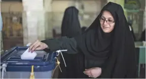  ?? MAJID SAEEDI, GETTY IMAGES ?? A woman votes in the parliament­ary and assembly elections in Qom, Iran. Early results indicated support for Iran’s nuclear deal with world powers.