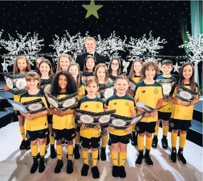  ??  ?? On song Sophia Gerrard is pictured left on the front row with her fellow choristers and Celtic boss Neil Lennon