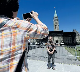  ?? SEAN KILPATRICK/THE CANADIAN PRESS ?? Tourists visit Parliament Hill in Ottawa last week as preparatio­ns for Canada Day are underway. Be alert but not alarmed, police are urging Canadians who will attend Canada 150 celebratio­ns next month.