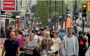  ?? AP ?? People walk along a shopping street in London as economists warn inflation is set to soar in Britain.