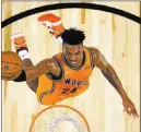  ?? Mark J. Terrill ?? The Associated Press Kings guard Buddy Hield soars to the basket Friday during the World team’s 155-124 win over the United States team in the NBA Rising Stars Challenge at Staples Center.