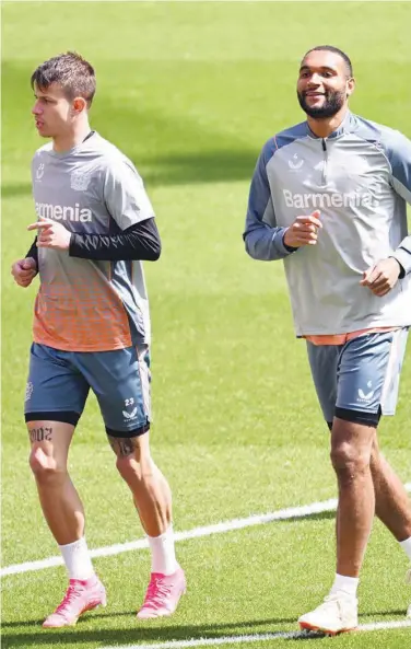  ?? Associated Press ?? Leverkusen’s Adam Hlozek (left) and Jonathan Tah attend a training session in Leverkusen on Wednesday.