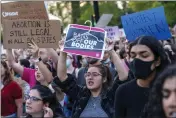  ?? JACQUELYN MARTIN — THE ASSOCIATED PRESS FILE ?? Fiorella Flores, center, a student at The Catholic University of America, joins demonstrat­ors in protest outside of the U.S. Supreme Court in Washington.