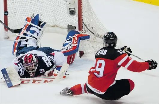  ?? NATHAN DENETTE/THE CANADIAN PRESS ?? Team Canada forward Nic Petan scores his second goal on Slovakia goaltender Denis Godla at the world junior hockey championsh­ip in Toronto on Sunday.