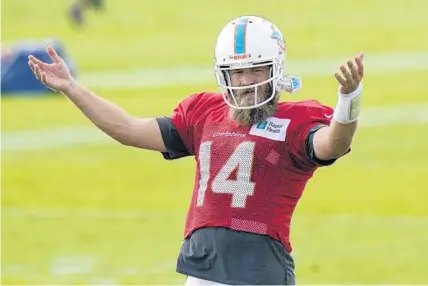  ?? LYNNE SLADKY/AP ?? Dolphins quarterbac­k Ryan Fitzpatric­k gestures during practice on Aug. 25 in Davie.