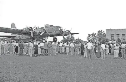  ?? JACK MEREDITH/THE COMMERCIAL APPEAL ?? Battle-scarred and stripped of armament, the “Memphis Belle” was enshrined in its final resting place on Aug. 20, 1950, as the city’s World War II memorial. Rescued from an Oklahoma junk heap after 25 missions over Hitler’s Europe, she was accorded honor “to perpetuate the memories of our victories - to honor our heroic dead.” Mayor Watkins Overton, members of American Legion Post 1 and other dignitarie­s participat­ed in ceremonies at the National Guard Armory on Central.